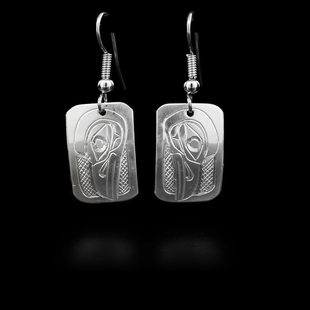 These dangling Raven earrings are made from sterling silver and there are small, rectangular hangs. There are depictions of the Raven carved into the surface of the hangs.