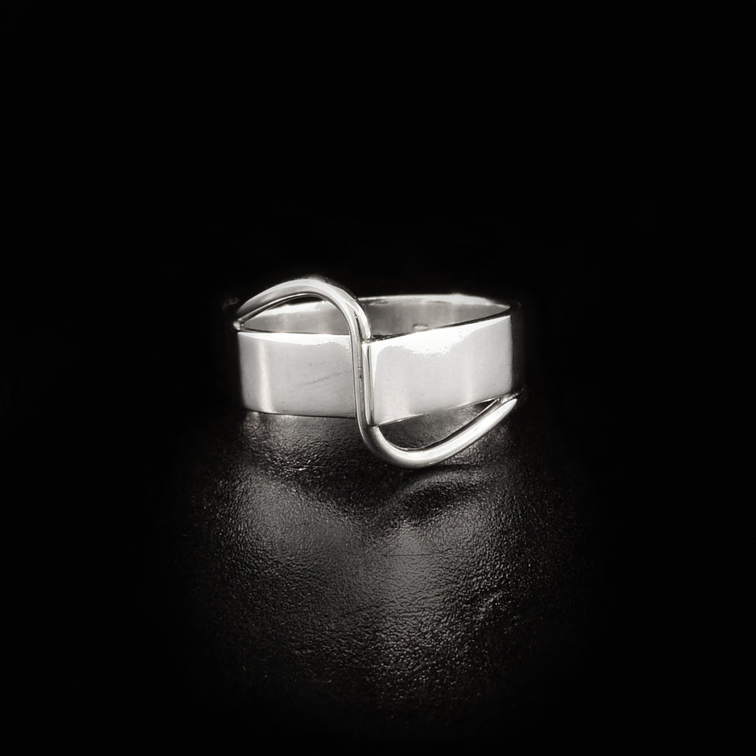 Front of band is joined together with one end sticking off artistically. A thin strip of sterling silver flows across front.