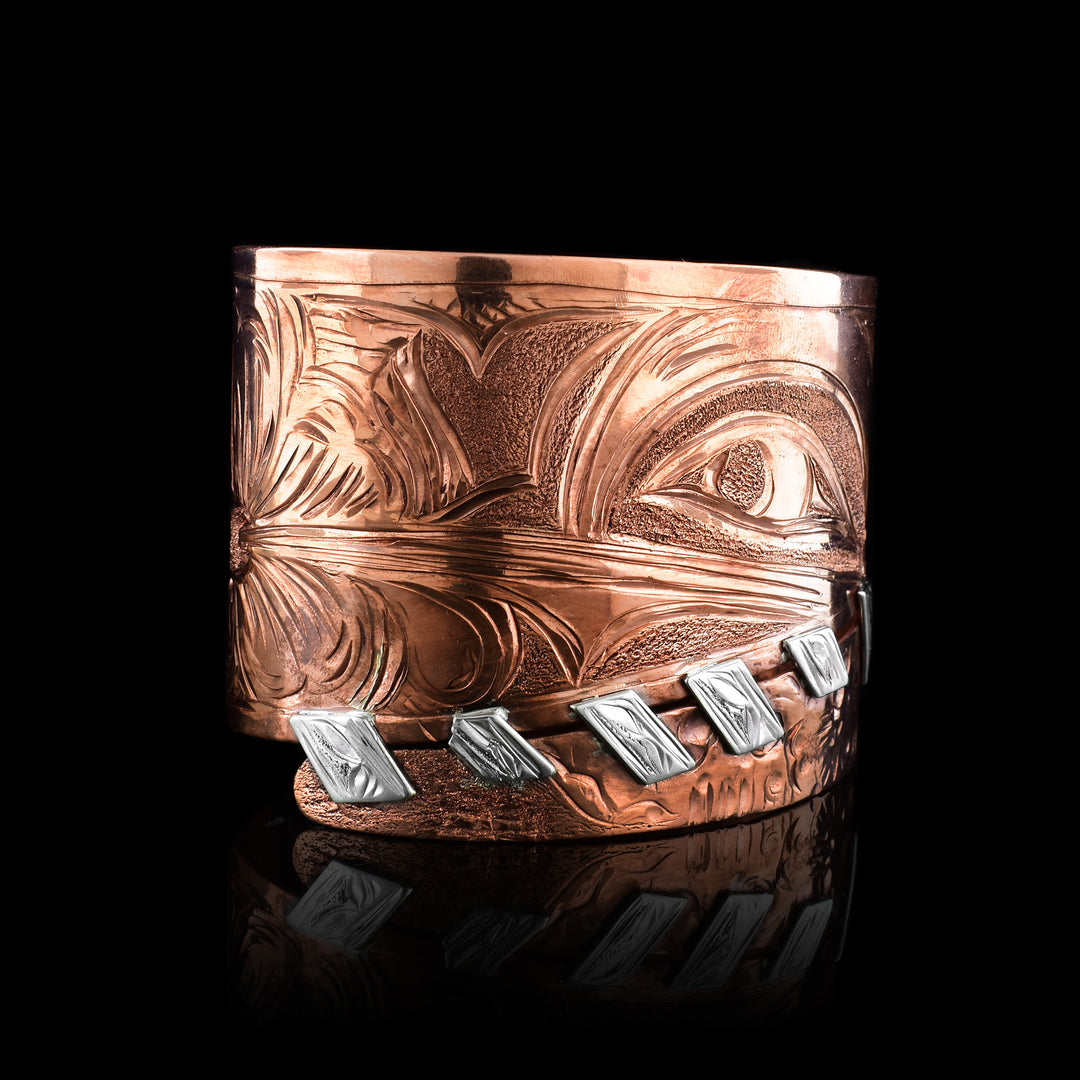 Hand-carved Copper and Sterling Silver Hummingbird Statement Bracelet by Kwakwaka'wakw artist Cristiano Bruno. This bold wrap-style cuff features masterful Northwest Coast formline engraving and unique silver "stitch" accents.