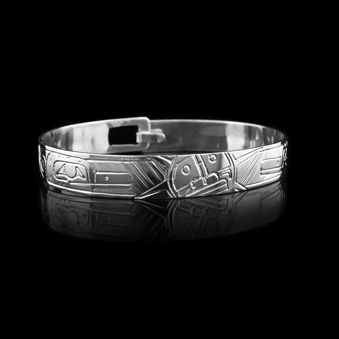 This Sterling silver bangle bracelet is carved with the sun and hummingbird legend on it. It clasps together at the back.