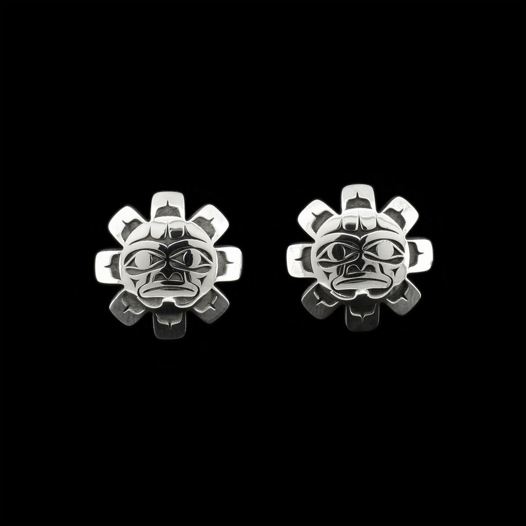Oxidized sterling silver sun stud earrings. Earrings are shaped like suns and have 3D faces.