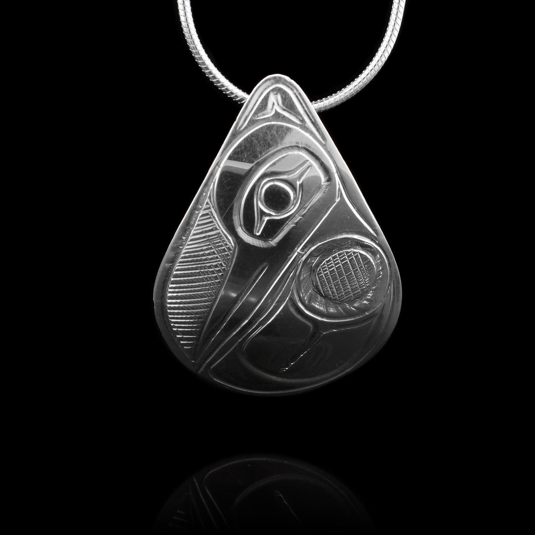 This Sterling Silver Teardrop Hummingbird Pendant is hand-carved with the symbolic image of the Hummingbird, its head s pointed down towards its wing.