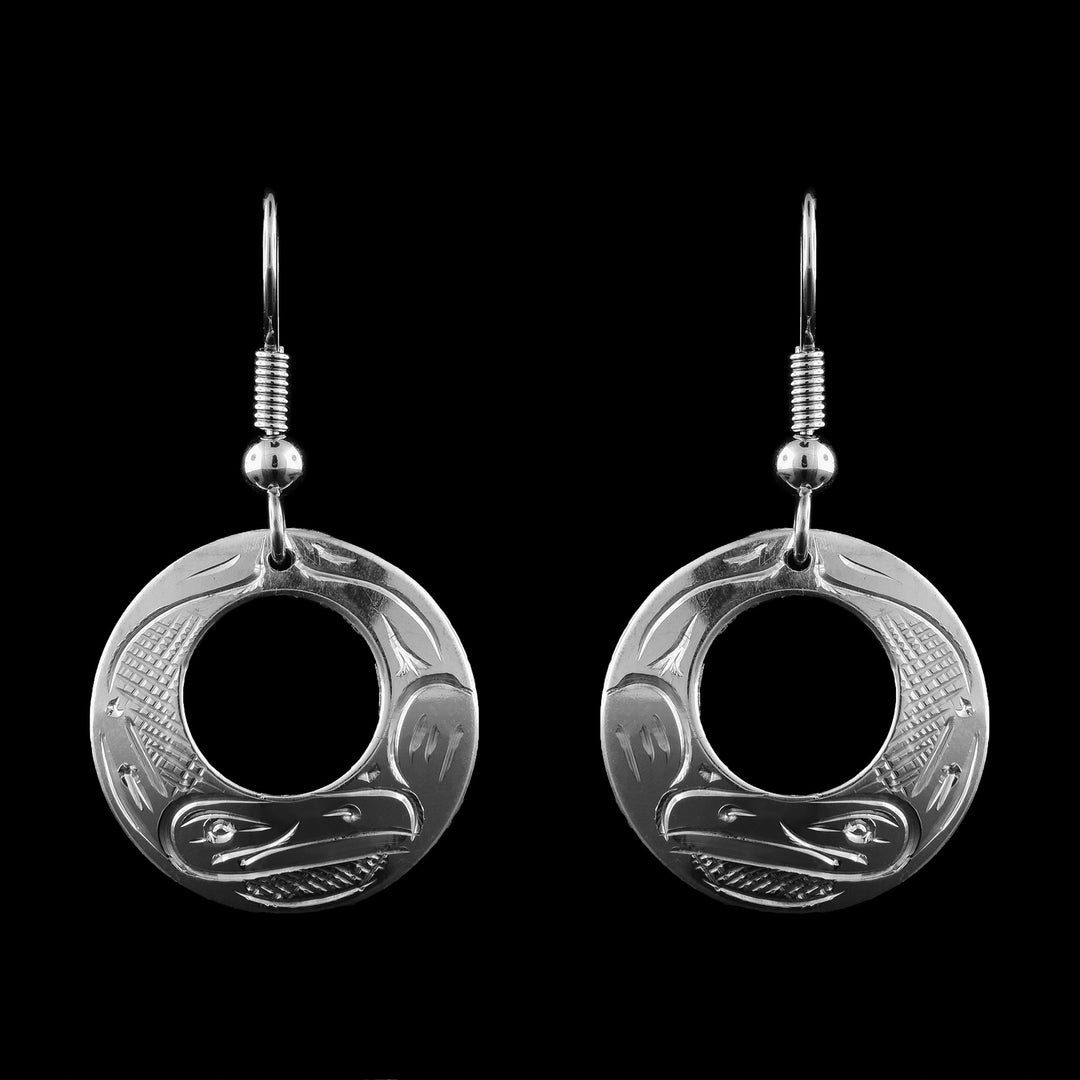 Handcrafted by Coast Salish artist Graham Henry, these Sterling Silver Thunderbird Earrings feature a contemporary open-circle design. The base of each earring is intricately engraved with the Thunderbird, a high-ranking spirit in Northwest Coast culture known as the guardian of the skies.