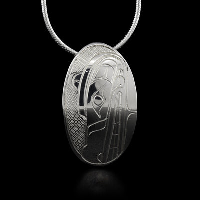 An oval sterling silver pendant that depicts the Wolf's head.