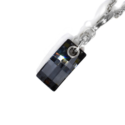 Rectangular charcoal Swarovski crystal hangs below interconnected sterling silver ring adornments leading up to bail. Pendant measures 2” x 0.5” including bail.