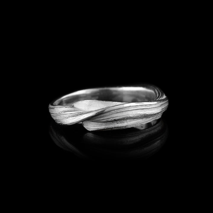 Shop this wavy sterling silver band by artist Lisa-Marie Masse. Hand-crafted with organic, flowing ridges and a brilliant polished finish. Wearable art in motion.