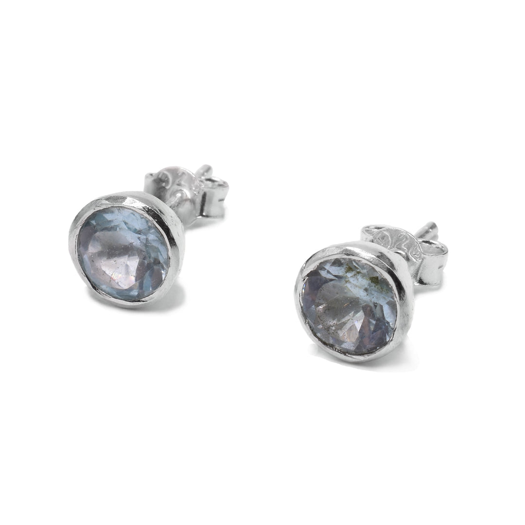 These dainty topaz earrings have delicate gems backed on sterling silver and they are circle shaped.