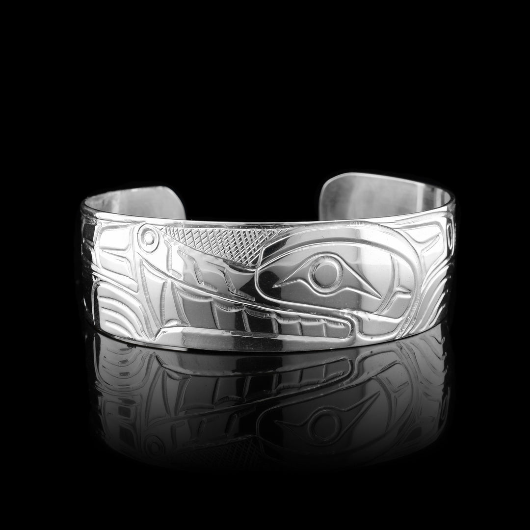 Sterling silver cuff bracelet with the legend of the wolf hand carved into it. 