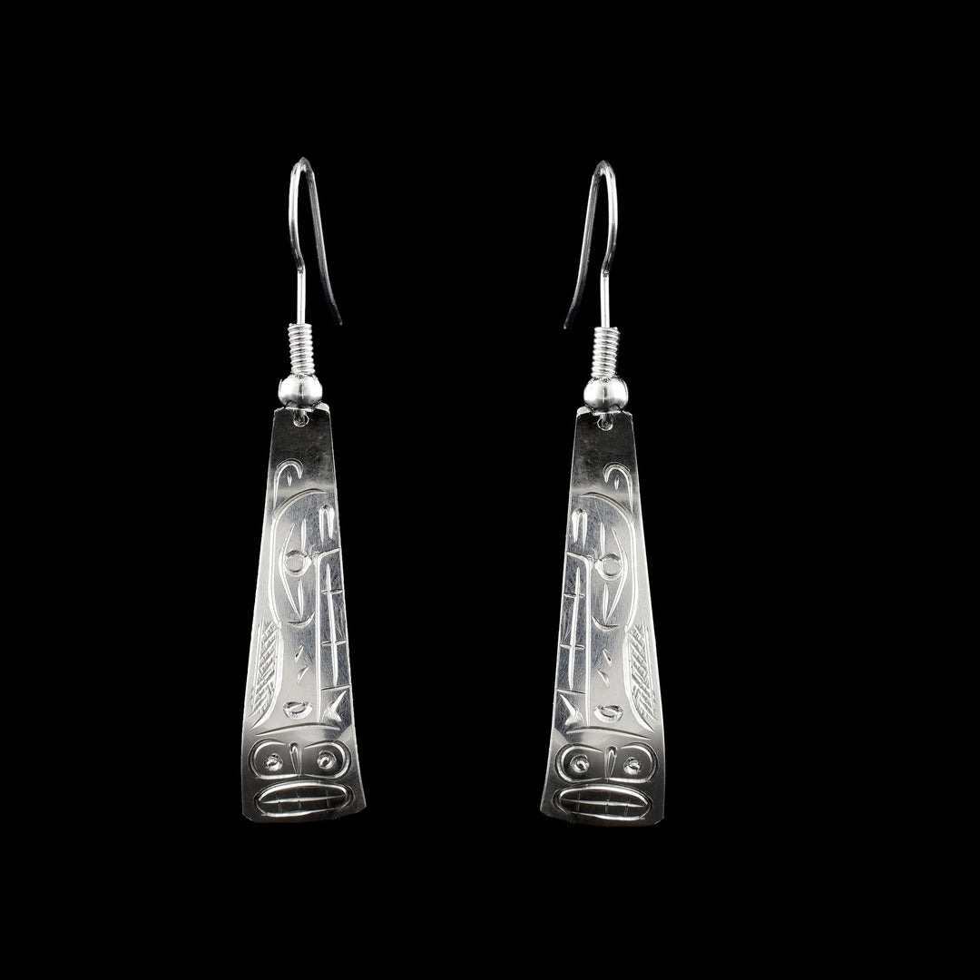 These sterling silver triangle earrings are hand carved with the legend of the Moon and the Wolf engraved on the surface of the silver dangle earrings. The Moon sits at the bottom of the earrings while the wolf stares down towards it.