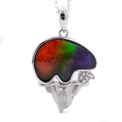 This sterling silver pendant depicts an ammolite bear as well as a small cub standing on a mountain.