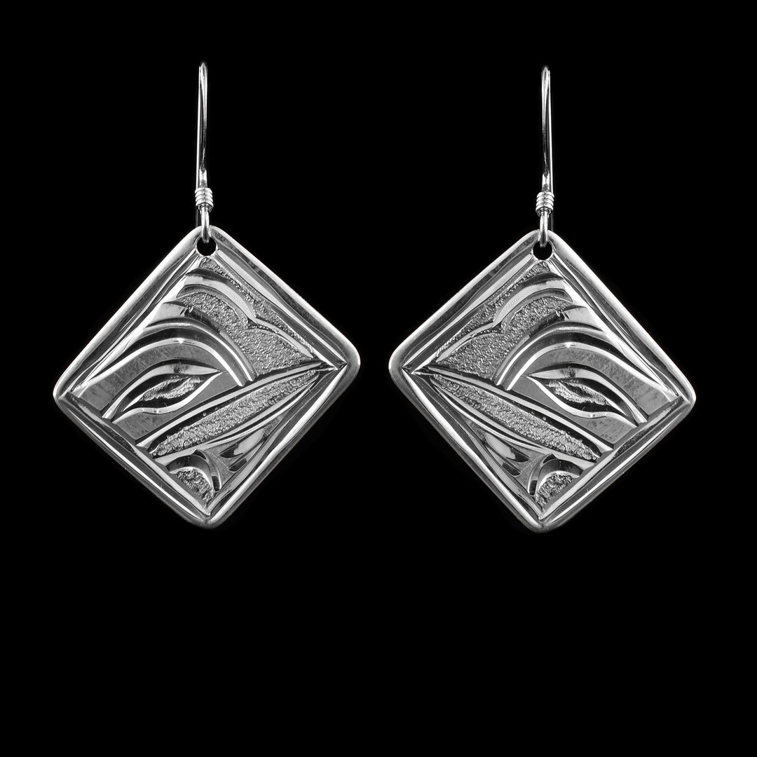 These sterling silver Hummingbird dangle earrings feature diamond-shaped drops with detailed carvings of a Hummingbird in side profile. They hang from the corners for a bold, unique look.