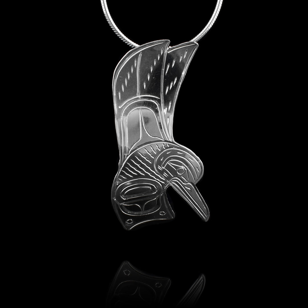 This sterling silver pendant features a beautifully detailed hummingbird design. The bird is shown in a dynamic pose with its wings raised, showcasing fine linework and carved patterns that emphasize movement and texture. The hummingbird’s long beak and expressive eyes are carefully engraved, capturing the elegance and energy of this beloved creature.