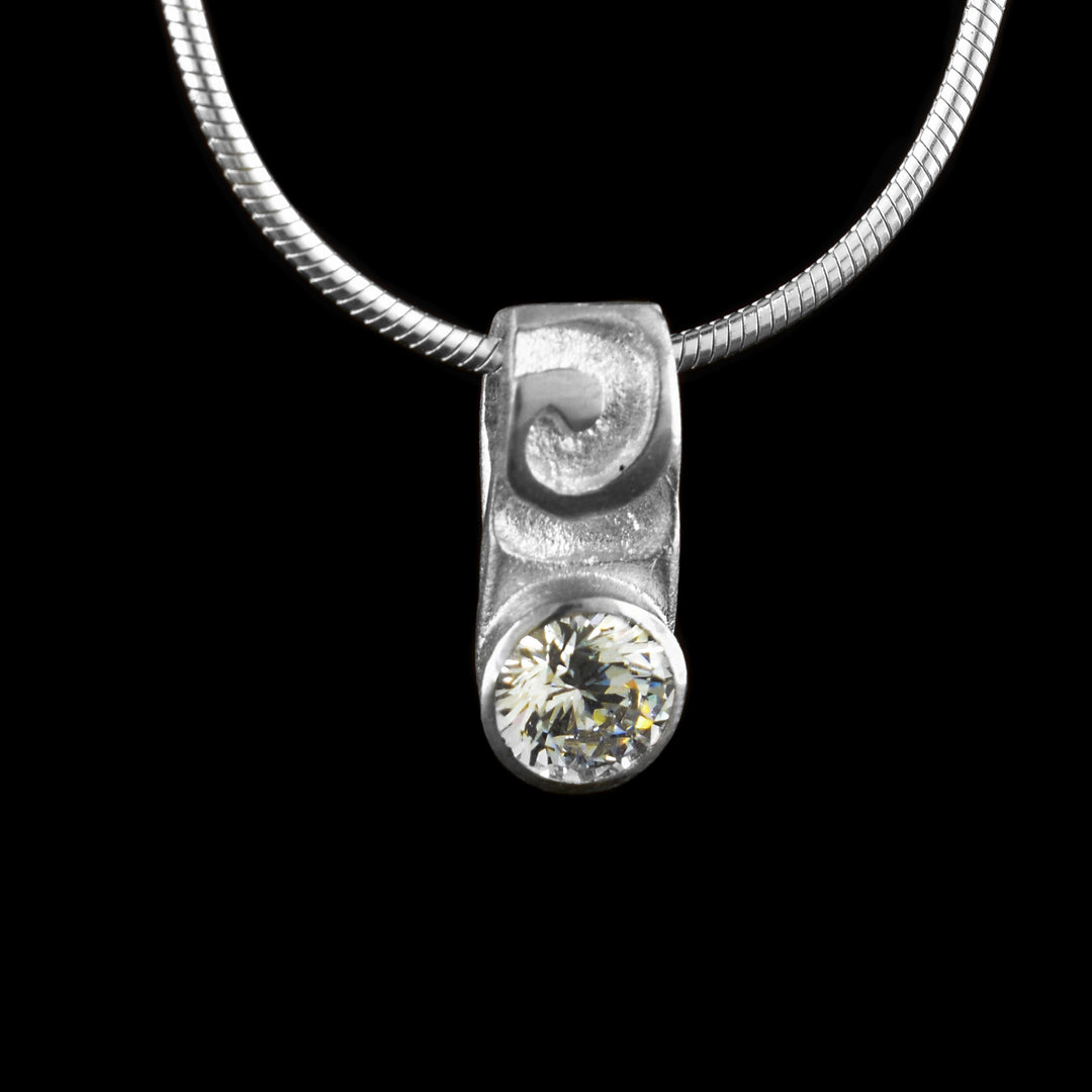 This elegant sterling silver pendant features a delicate swirl design at the top and below is a Dimond like gem.