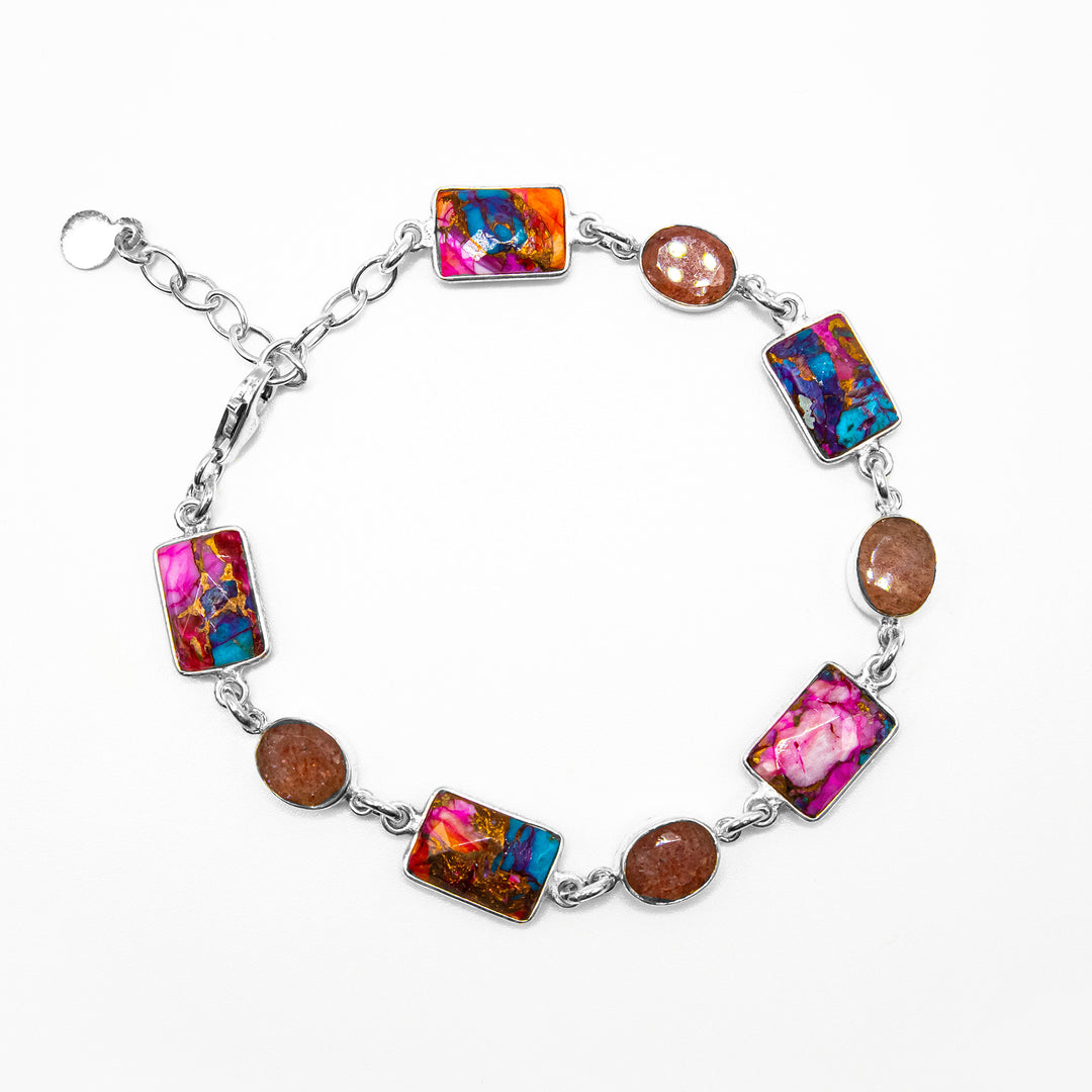 Sterling silver chain bracelet with alternating faceted beads. Larger, rectangular beads are oyster shell and smaller, oval beads are strawberry quartz.