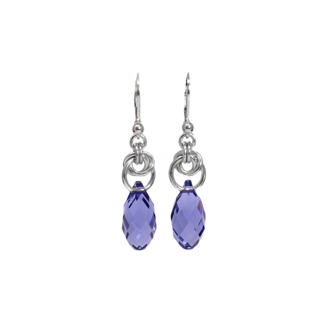 Teardrop tanzanite Swarovski crystals hang from interlocking silver rings. Flange hooks.