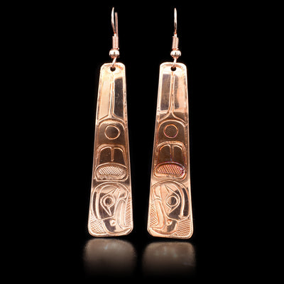 Earrings feature eagles facing downwards. Earrings get wider towards bottom. Hand-carved by Kwakwaka’wakw artist Norman Seaweed.