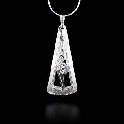 Sterling silver rounded, triangular pendant featuring hummingbird pointing downwards with beak in flower on bottom. Hand-carved and cut by Kwakwaka’wakw artist Harold Alfred.