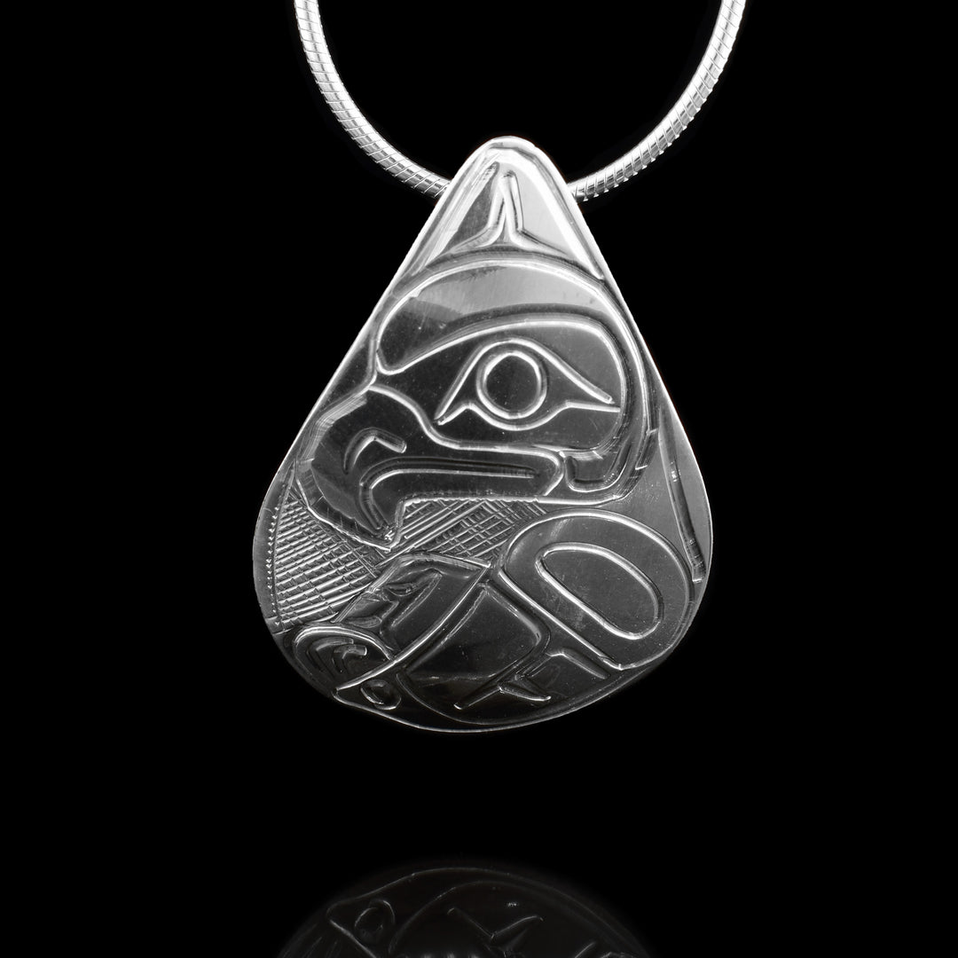 This Teardrop Silver Eagle Pendant is made with sterling silver. The teardrop has the eagles head carved into the top and at the bottom on of its wings is extended. 