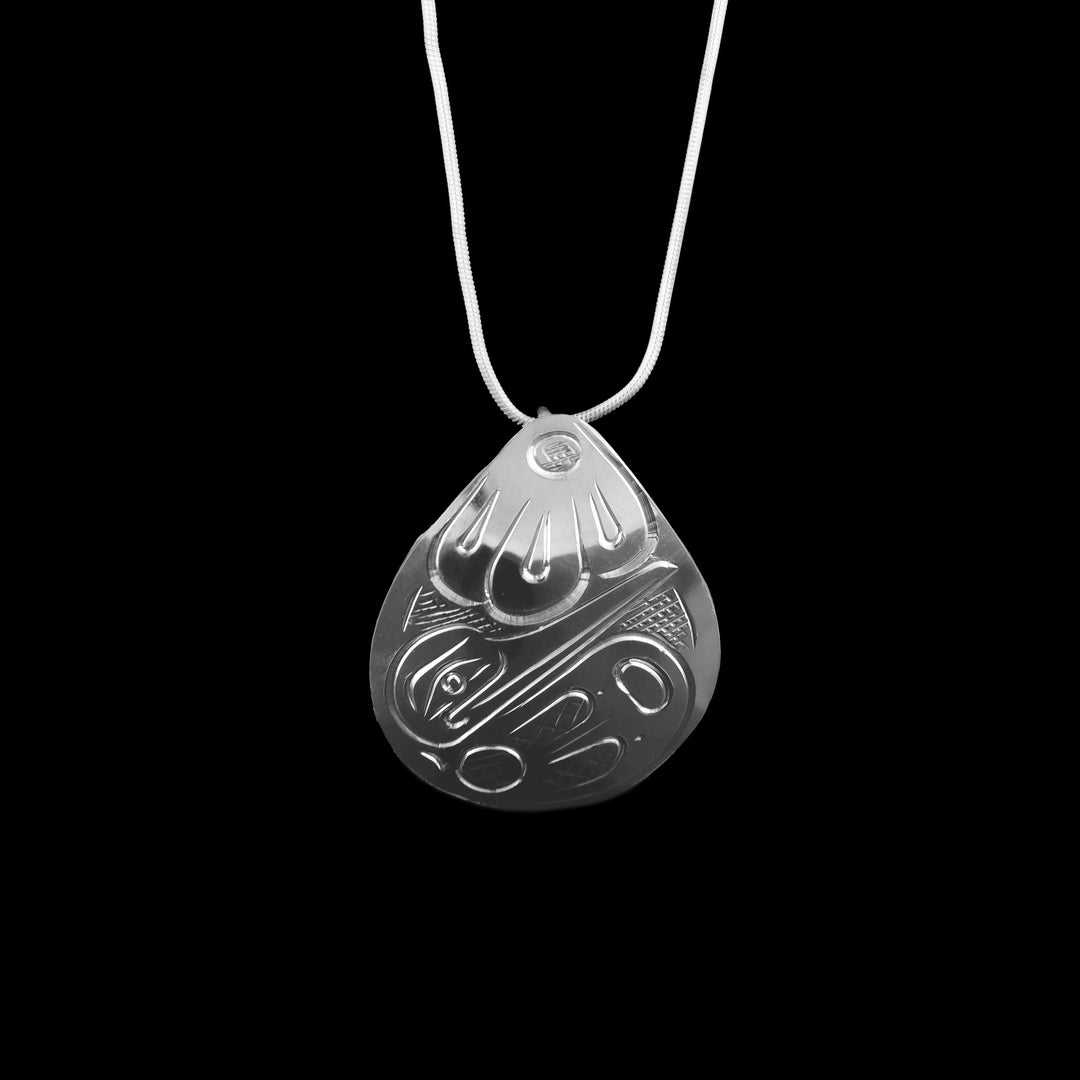 The teardrop has been made with sterling silver and the legend of the Hummingbird has been carved into the surface of the Pendant. 