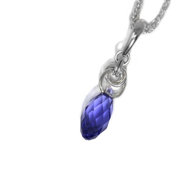Teardrop tanzanite Swarovski crystal hangs below interconnected sterling silver ring adornments leading up to bail. Pendant measures 1.5” x 0.7” including bail.