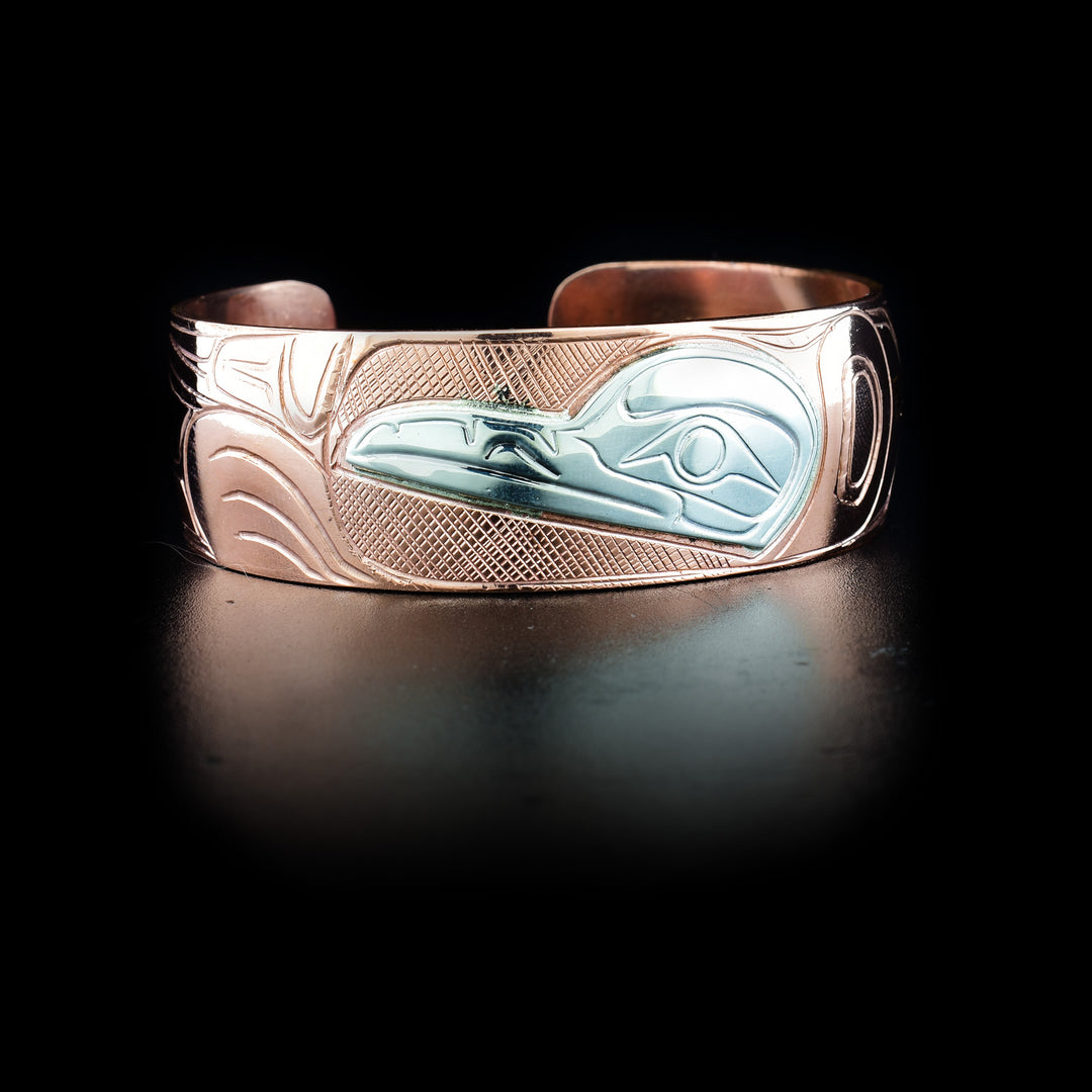 Copper cuff bracelet featuring sterling silver raven head on front. Hand-carved by Kwakwaka’wakw artist Cristiano Bruno.