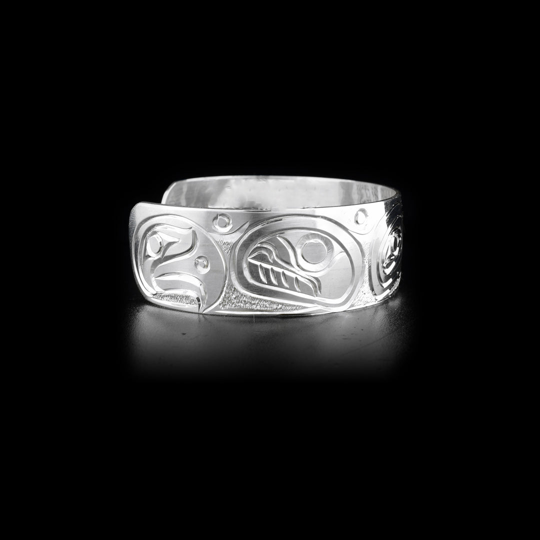 Right side of sterling silver cuff bracelet featuring orca and eagle.