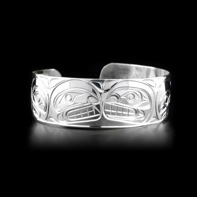 Right front view of sterling silver cuff bracelet featuring orca pod.