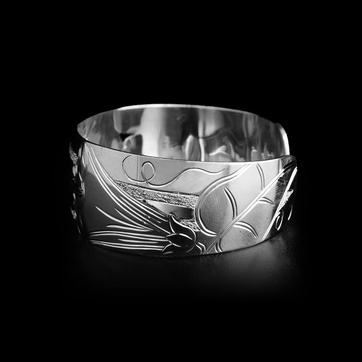 Left side of bracelet depicts floral designs with another cut out part.