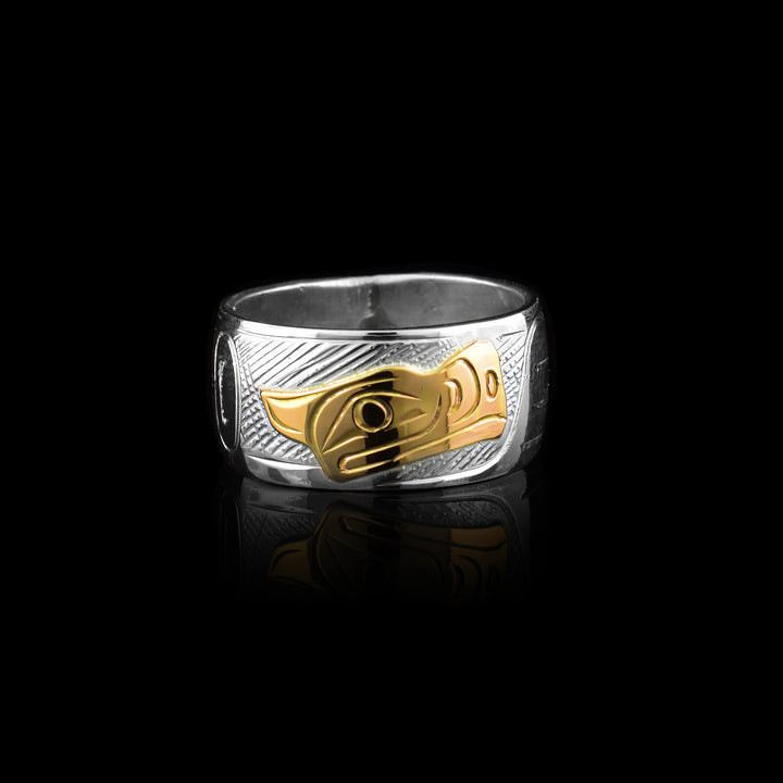 This sterling silver Thunderbird band ring is hand-carved with a 10k gold center piece of the Orcas head.