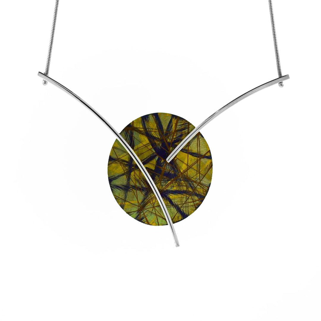 This unique titanium necklace is made from anodized titanium and sterling silver with a small, circle pendant. The pendant is made from anodized titanium and has colorful designs with silver wires that run across it and branch out from the pendant. The chain is attached to the end of these wires.