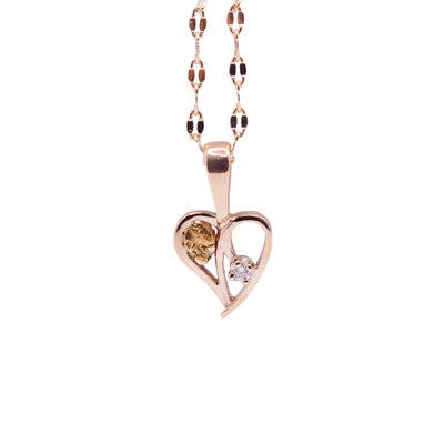 This gold diamond heart pendant is made from a 10K gold, cutout heart that has a 22K gold nugget on one side and a 3 - point diamond on the other.