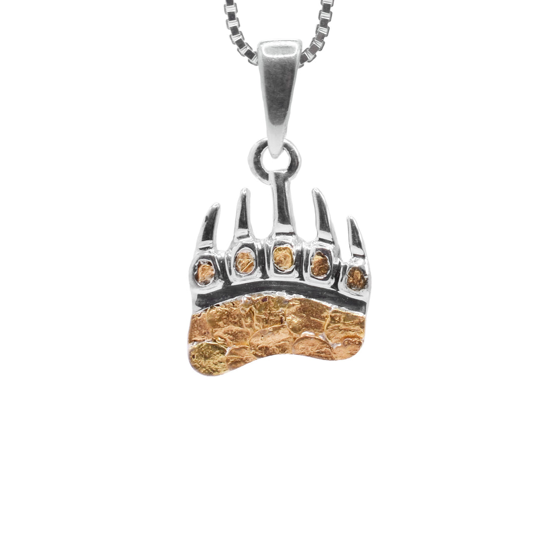 This small 22K gold nugget pendant is made from sterling silver that is shaped like a bear paw with claws. The pendant is filled in the sole and the toes of the paw with 22K gold nuggets.
