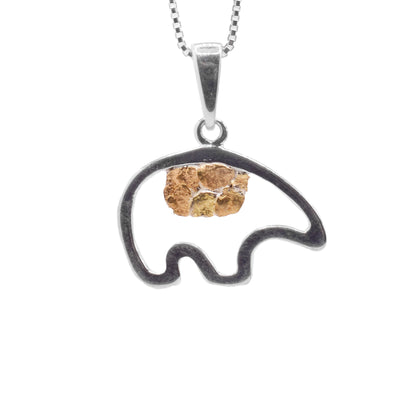This gold bear pendant has a simple silhouette of a bear made from a thin piece of sterling silver. The bear is empty in the middle and there is a 22K gold nugget framed in the middle of it.