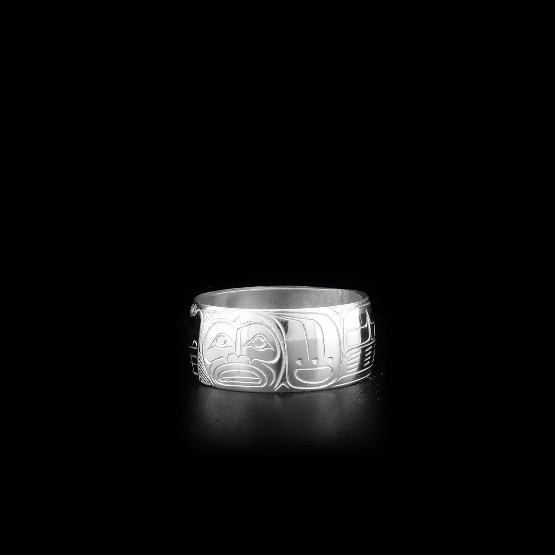 This Moon and Wolf ring is made from sterling silver. It has a wide band and there are depictions of the Wolf and the Moon carved into the surface of it.