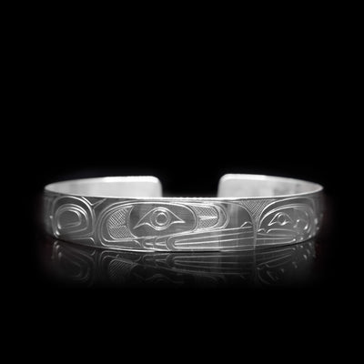 This large, sterling silver cuff bracelet has a depiction of the Orca carved into the surface of the band.