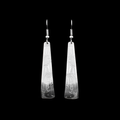 These sterling silver dangling earrings have long, tapered hangs with depictions of the Thunderbird carved into the surface of them.