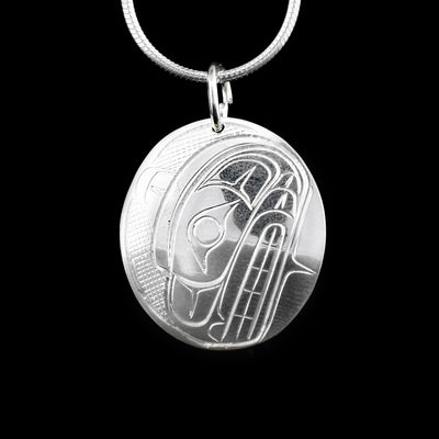 This sterling silver pendant is oval shaped and has a depiction of the Bear carved into it.