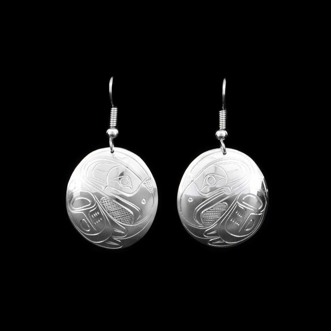 These Eagle earrings are made from sterling silver and has large, circular hangs. There are depictions of the Eagle carved into the surface of the hangs.