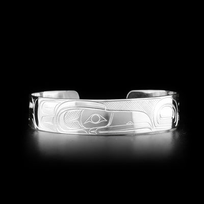 This sterling silver cuff bracelet has a single band with a gap in the back. There is a depiction of the Raven carved into the surface of the band.