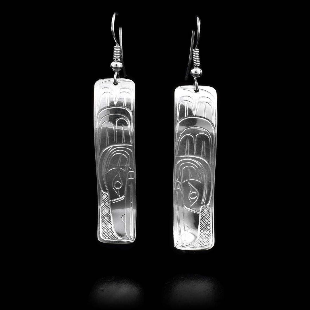 These sterling silver dangle earrings have rectangle shaped hangs with depictions of the Raven carved into the surface of them.