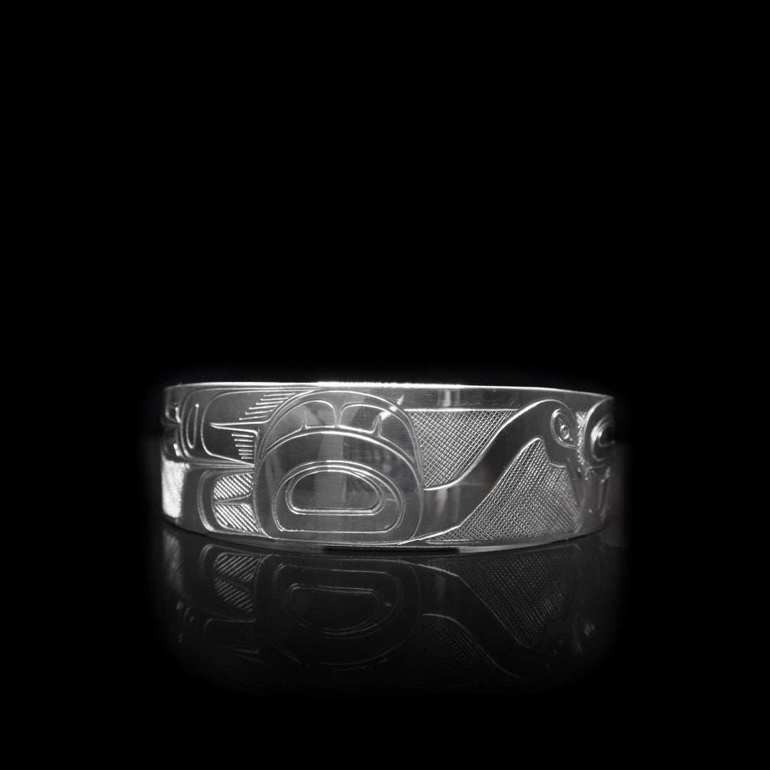 This sterling silver cuff bracelet has a depiction of the Swan carved into the surface of the band.
