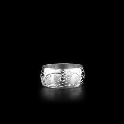 This sterling silver band ring has a wide band width a depiction of the Thunderbird carved into the surface of the band.