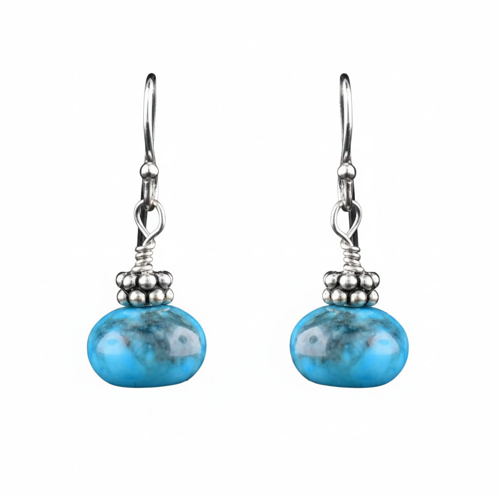 Sterling silver earrings with hand-cut sphere turquoise stones, artisan-crafted by Johanne Rousseau. Elegant, timeless design.