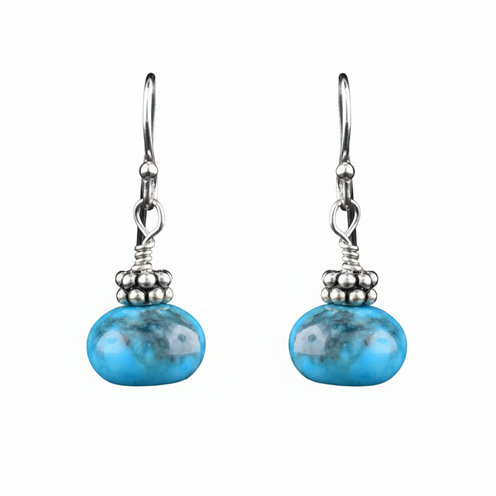 Sterling silver earrings with hand-cut sphere turquoise stones, artisan-crafted by Johanne Rousseau. Elegant, timeless design.