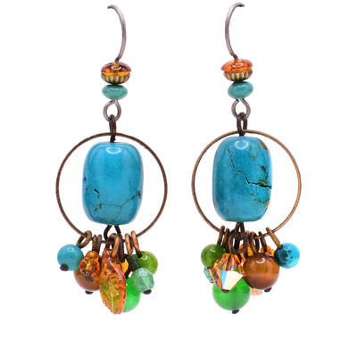 Dangle earrings made of Austrian crystal, handworked brass, turquoise, baltic amber, tiger's eye, aventurine, glass and resins. Titanium hooks. By Honica.