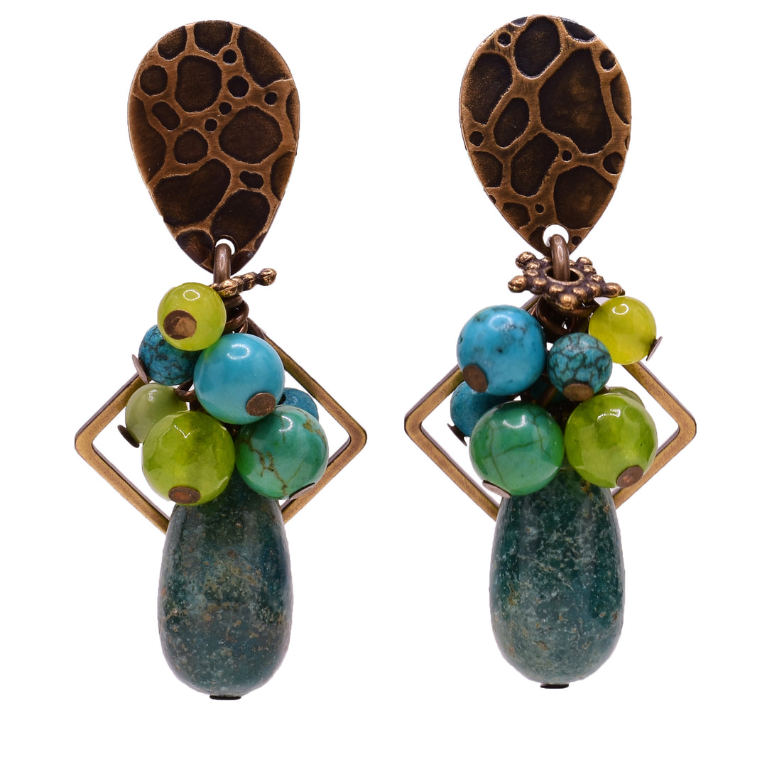 Dangle stud earrings made of mother of pearl, handworked brass, turquoise, serpentine, jade and magnesite. Titanium ear posts. By Honica.
