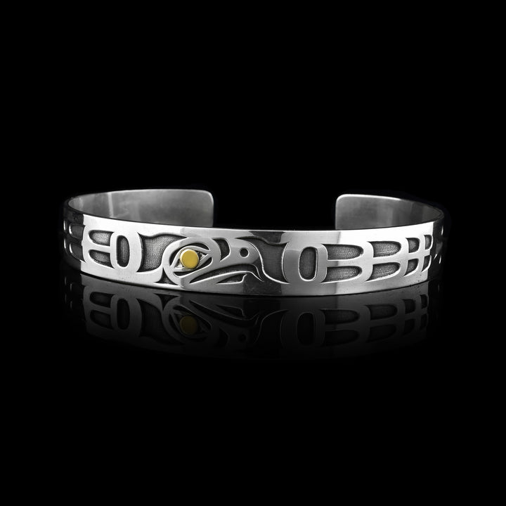 Two-Toned Eagle Cuff Bracelet. Carved from sterling silver the legend of the eagle into the cuff. With 14k gold used for the eye of the eagle.