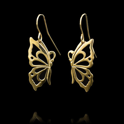 The solid 14K gold dangle earrings are shaped like and have several decorative cutouts that depict butterflies.