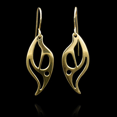 The solid 14K gold dangle earrings are shaped like and have multiple decorative cutouts that depict flames.