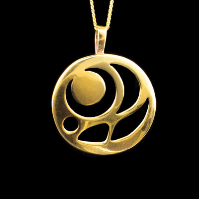 This 14K gold pendant is circle shaped and there are multiple cutouts that depict an egg from the Salmon.